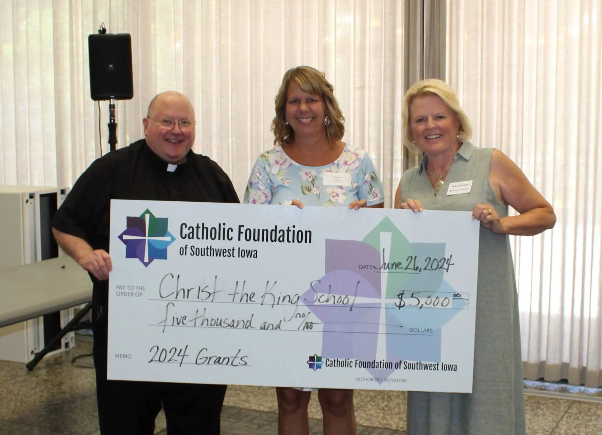 Teachers from Christ the King accepting grant from CFSWIA