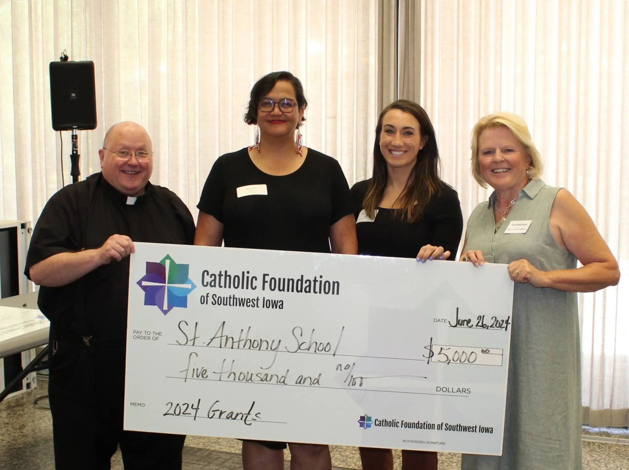 Teachers from St. Anthony accepting grant from CFSWIA