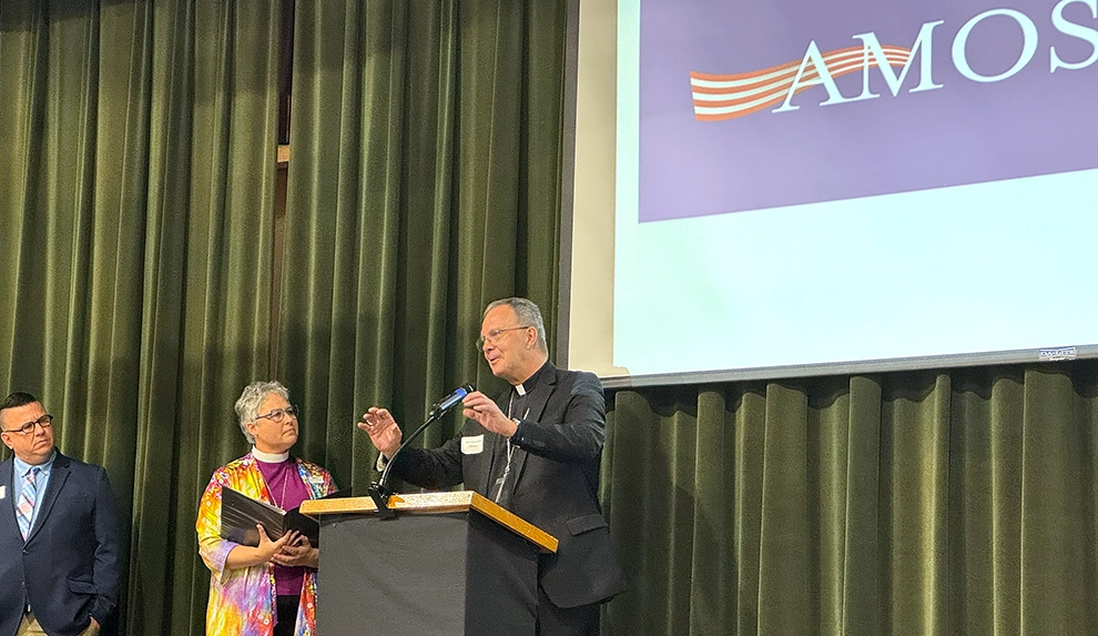 Bishop William Joensen speaks before an AMOS conference