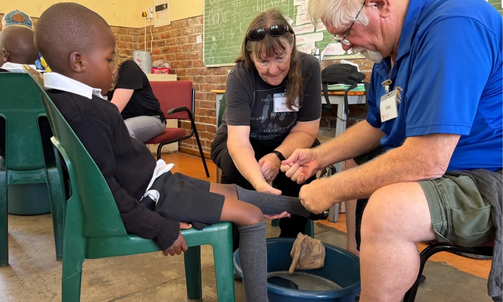 St. Francis volunteers washing a child's feet at Subiaco Primary School