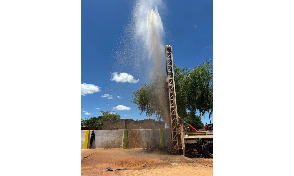 Water spraying in the air after Blessman International drilled a well