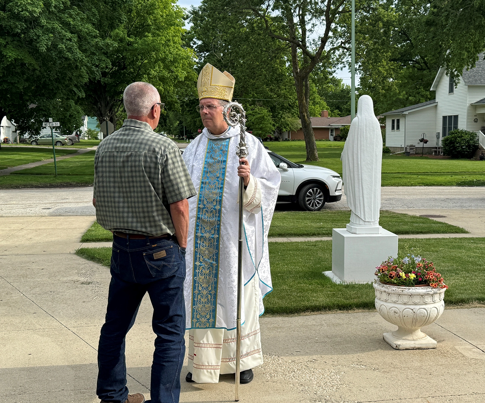 Bishop William Joensen listens to a man share his experience with a tornado