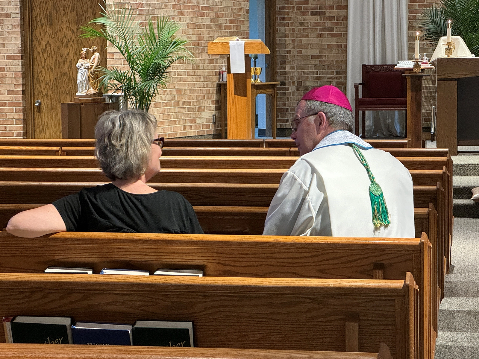 Bishop William Joensen listens to a woman share her exp