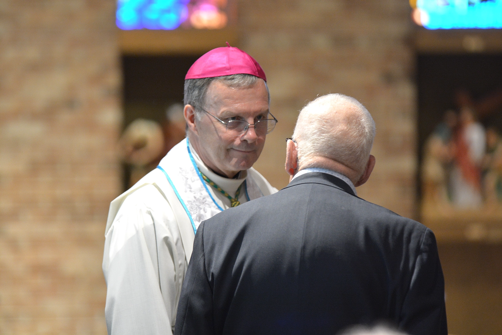 Des Moines Bishop William Joensen visits with a parishi