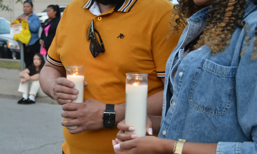 2 people holding candles at Sunday's prayer vigil
