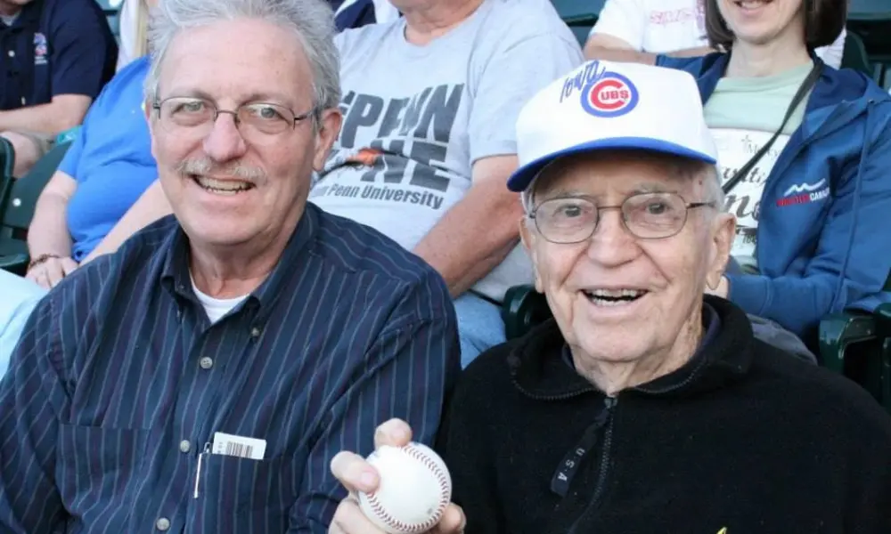 Father Greg Leach and his father at a baseball game