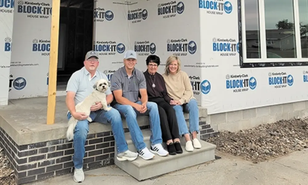 The McDermott family sits by their new home