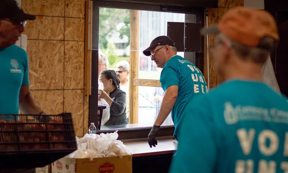 Volunteers hand out food at the Catholic Charities Food