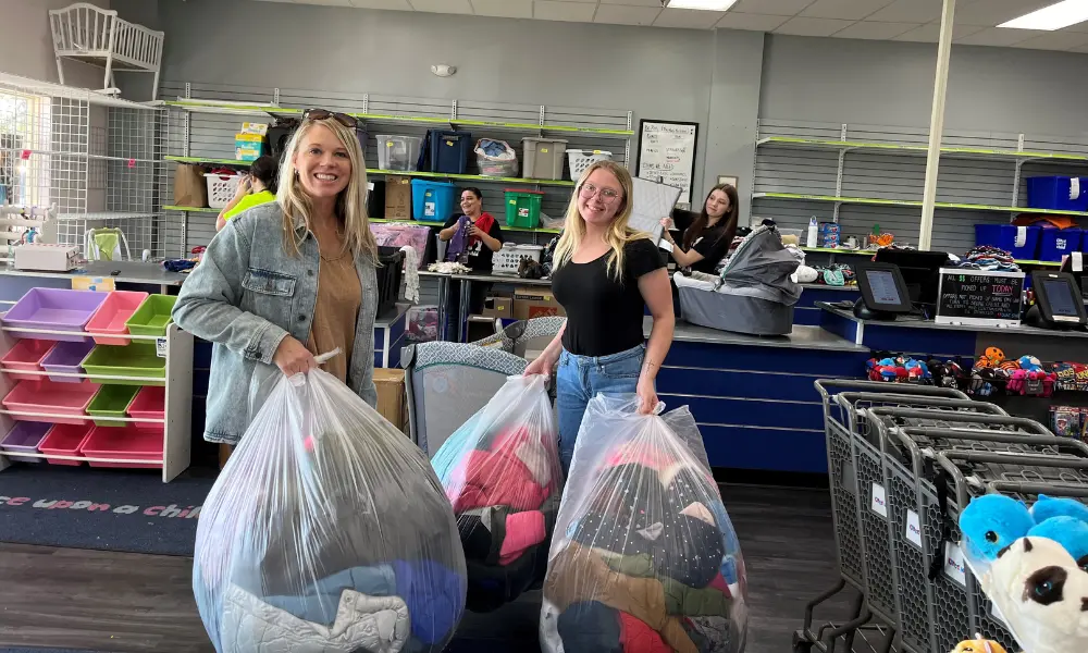 Once Upon a child in Urbandale donates dozens of winter coats for Catholic Charities’ Refugee Services clients.