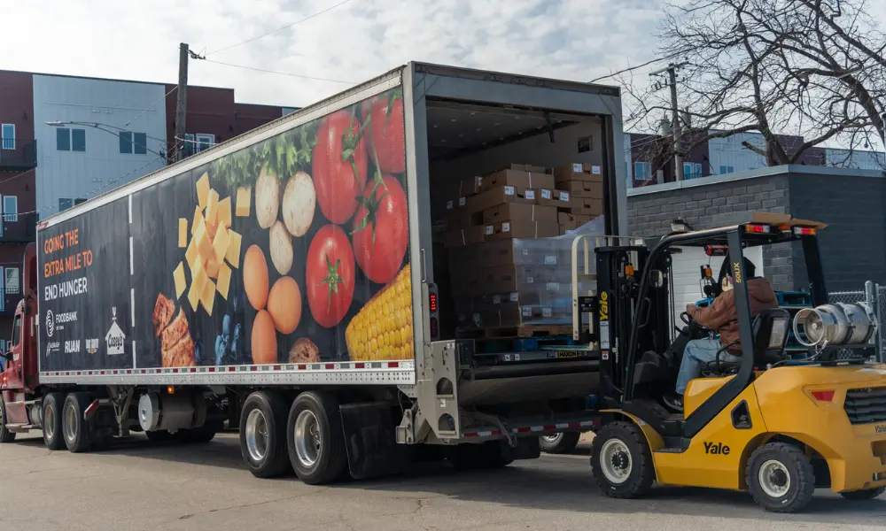 Volunteer unloading a semi-truck of donations at the Fo