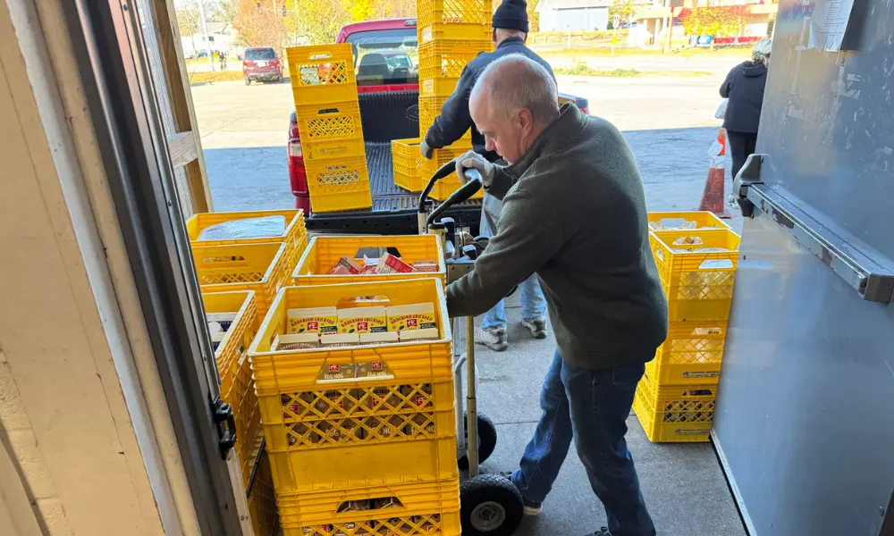 Executive director of Catholic Charities, Mike Sheehy, unloading donations