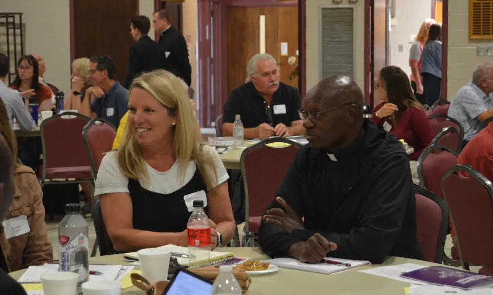 Fr. Protas Okwalo, SJ and Julie Solkowski during a small group discussion at the OCIA workshop.