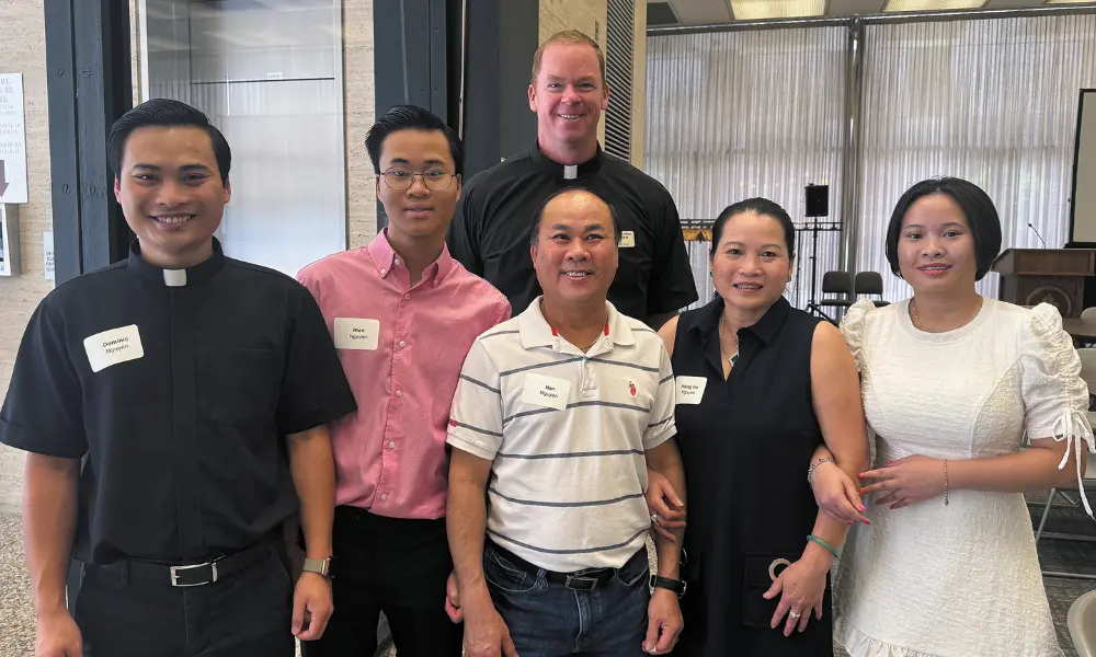 Seminarian Dominic Nguyen with his family and Fr. Ross 