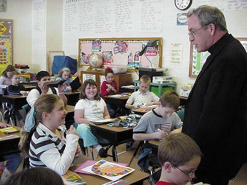 Monsignor Steve Orr visits a classroom